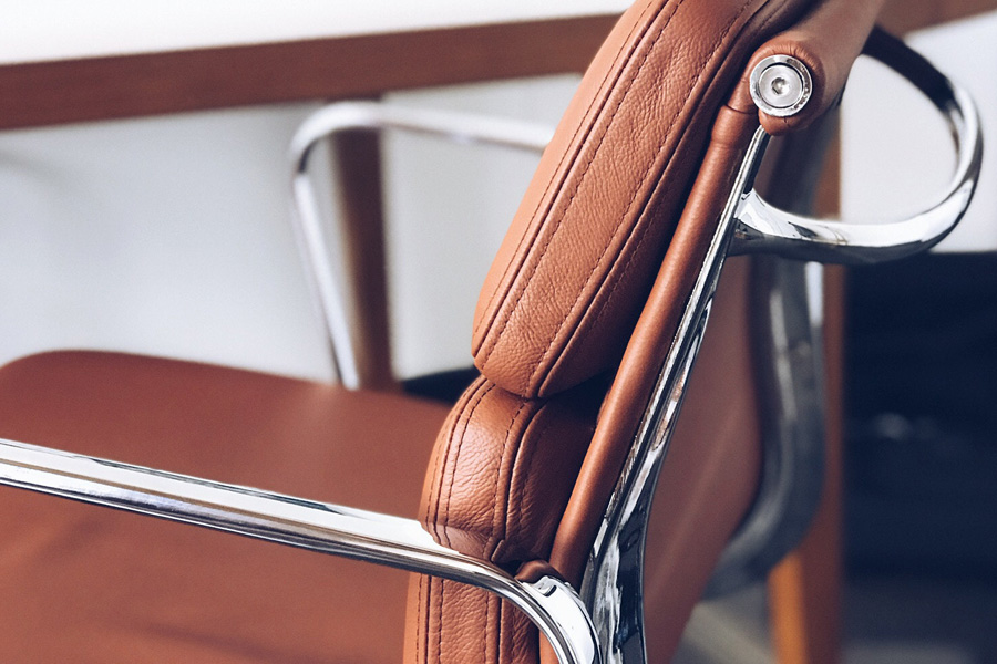 Designer chair in chrome and brown leather.