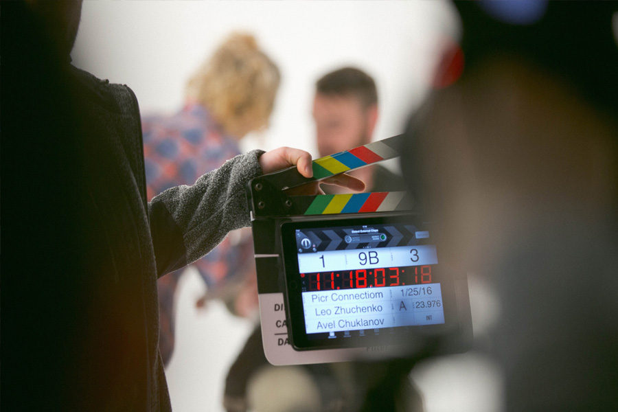 Person holding a clapperboard on a film set