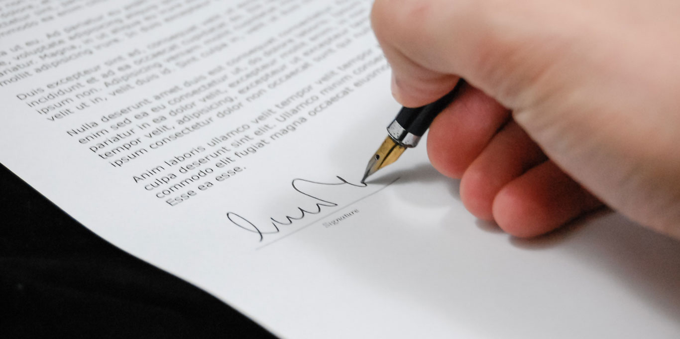 Hand signing a contract