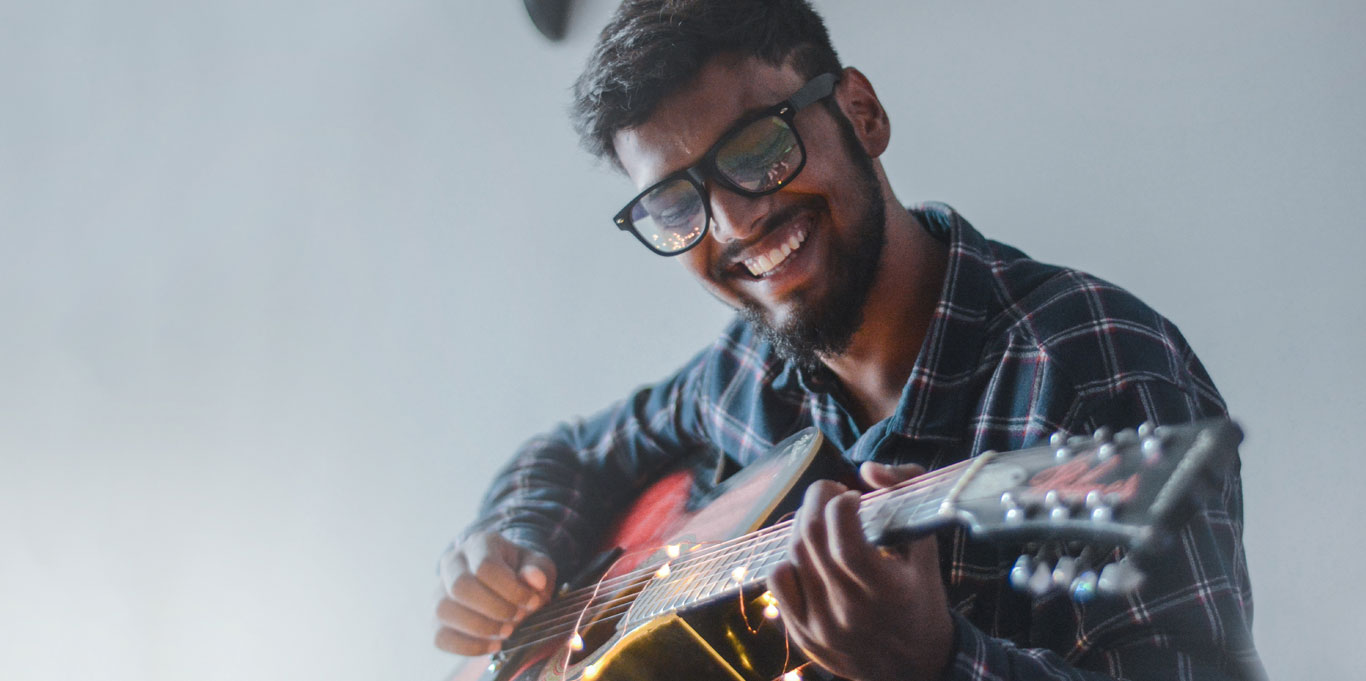 Male musician plays a guitar