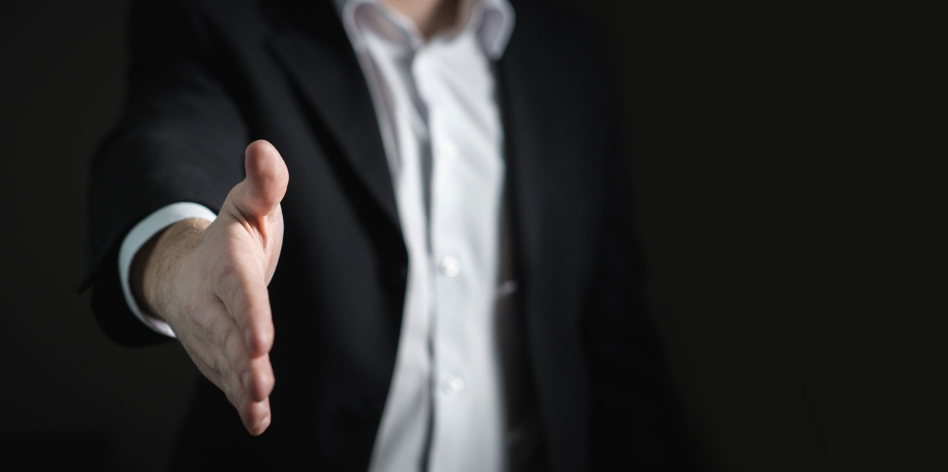 A businessman extending his hand for a handshake