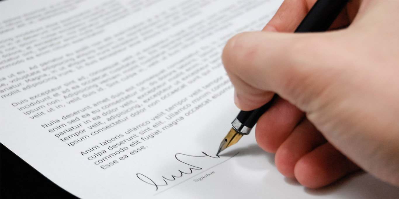 Hand signing a contract