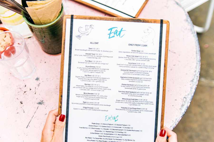 Girl holding a traditional café menu