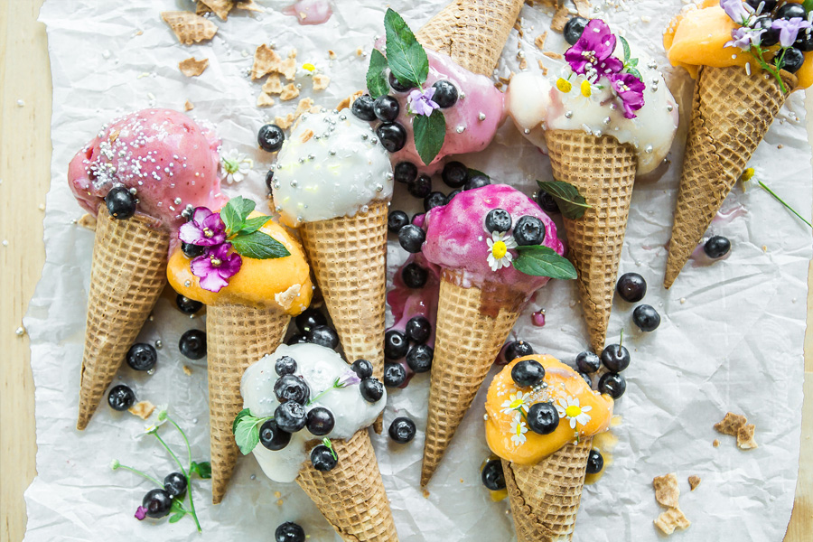 Ice-cream cones with blueberries and flowers.